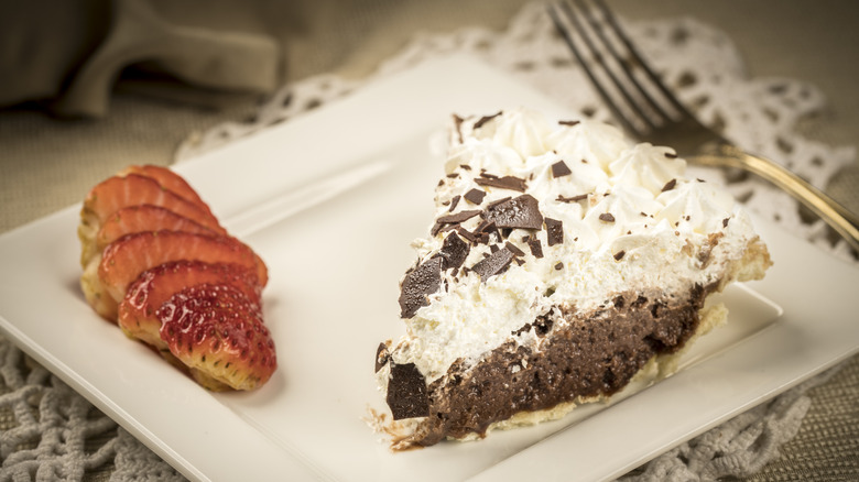 Chocolate sin pie with slice of strawberries