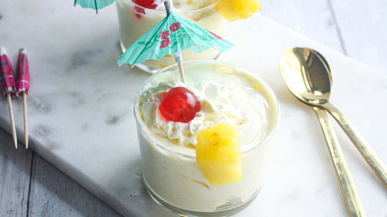 Small glass with creamy blended pineapple drink.