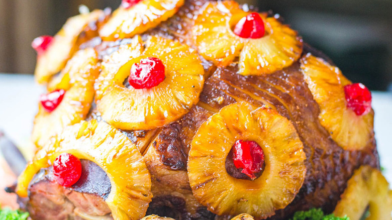 Spiral ham with pineapple rings and maraschino cherries.