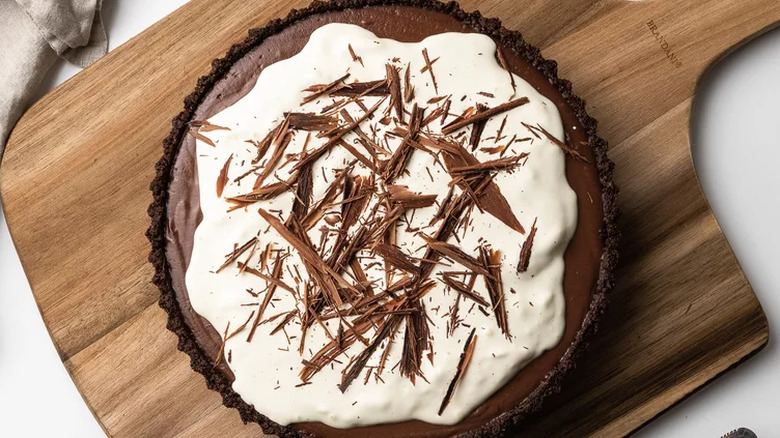 Chocolate filling in chocolate pie crust with whipped cream.