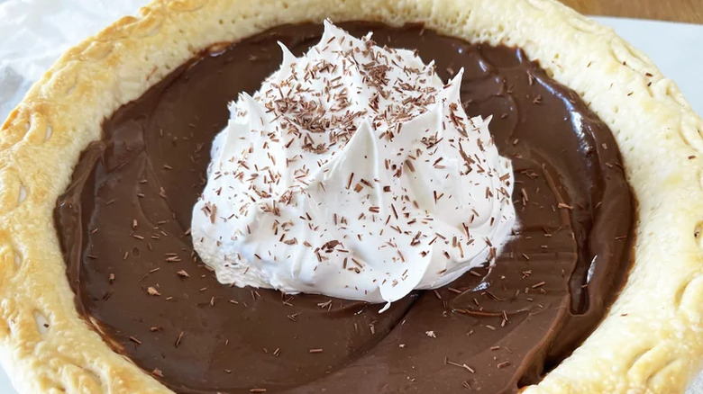 Baked pie shell with chocolate pudding filling and whipped cream.