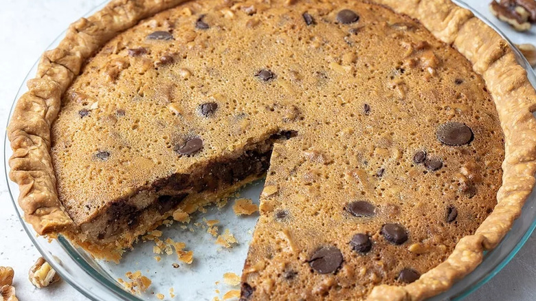 Pie with chocolate-cookie-nut filling with slice out.