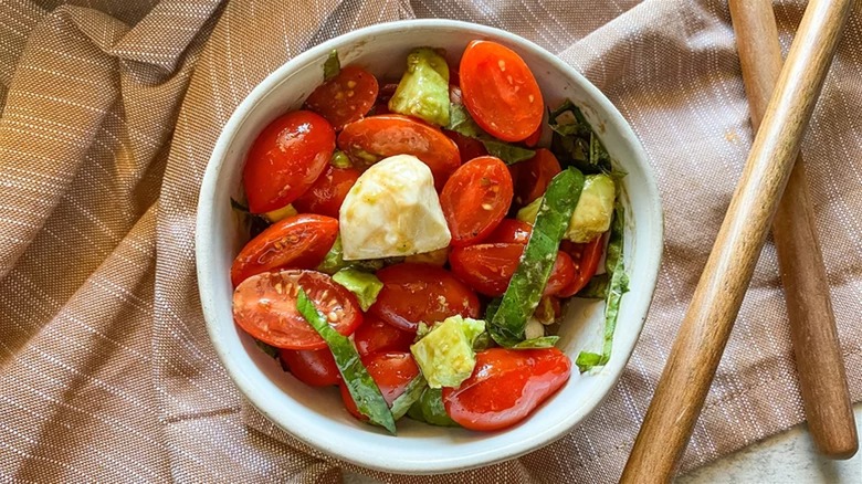 Avocado Caprese salad in white bowl