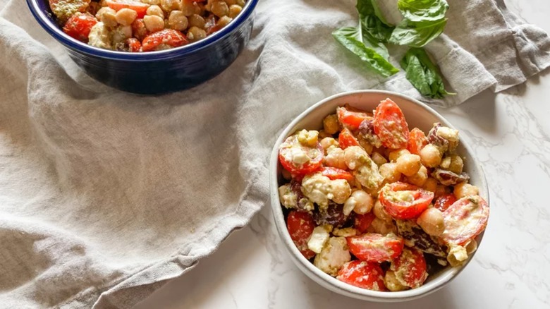 Pesto chickpea salad in white bowl