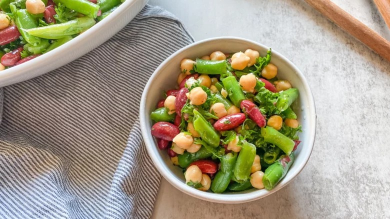 Three bean salad in white bowl