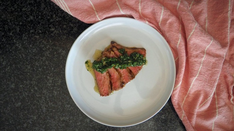 sliced steak with herb sauce