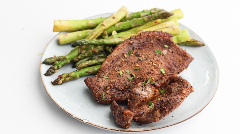 steak with asparagus on plate