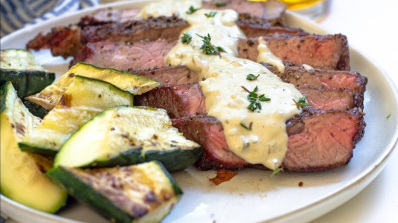 steak with cream sauce, zucchini