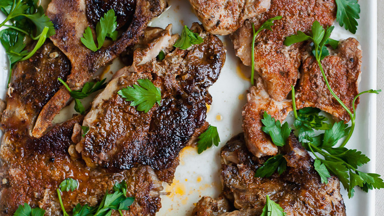 pork steaks covered in parsley