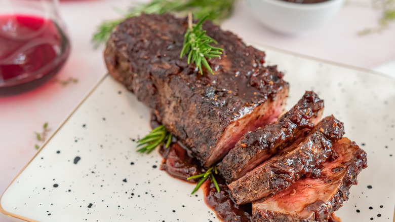 sliced steak with herb garnish