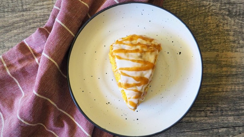 Frosted pumpkin scone on plate