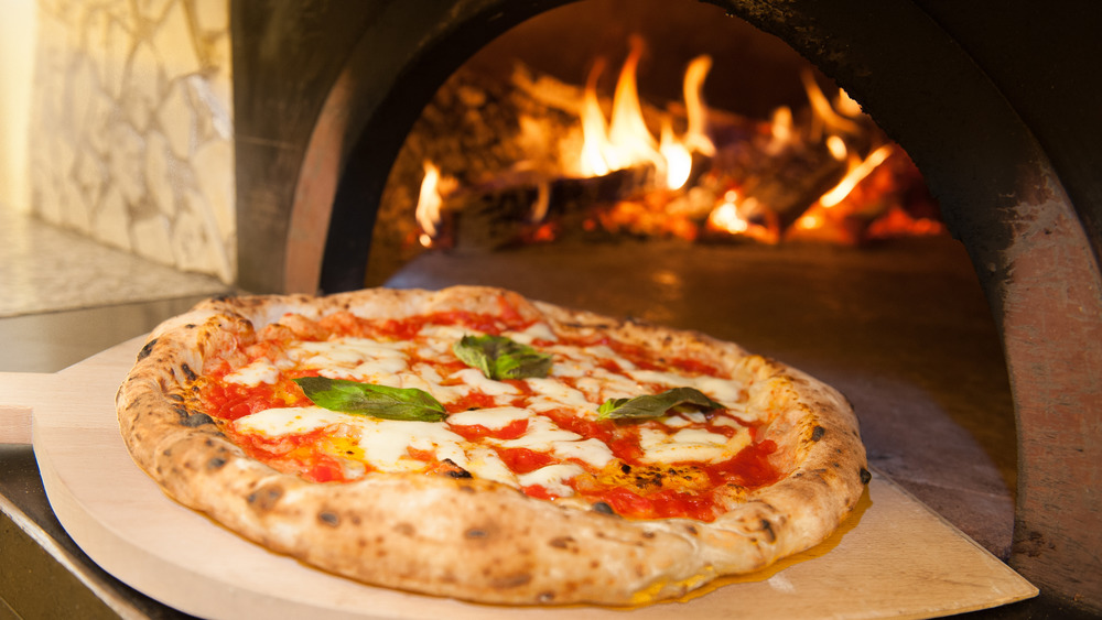 Pizza near a wood-fired pizza oven