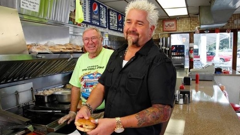 Guy Fieri with eatery owner on Triple D