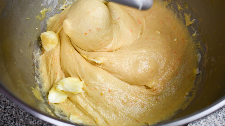 Softened butter pieces in mixing dough