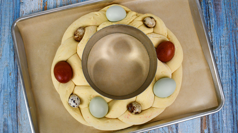 Shaped Easter bread dough with eggs