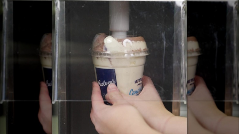 person making Culver's frozen cocoa