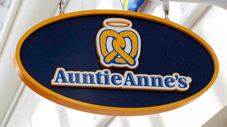 Hanging Auntie Anne's sign at mall