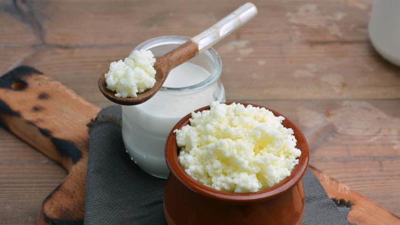 Keffir, milk, and yoghurt against a wooden background