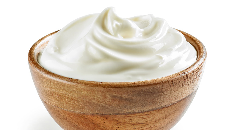 Sour cream in a wooden bowl