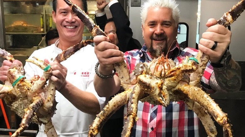 Benny Lin and Guy Fieri holding giant crabs