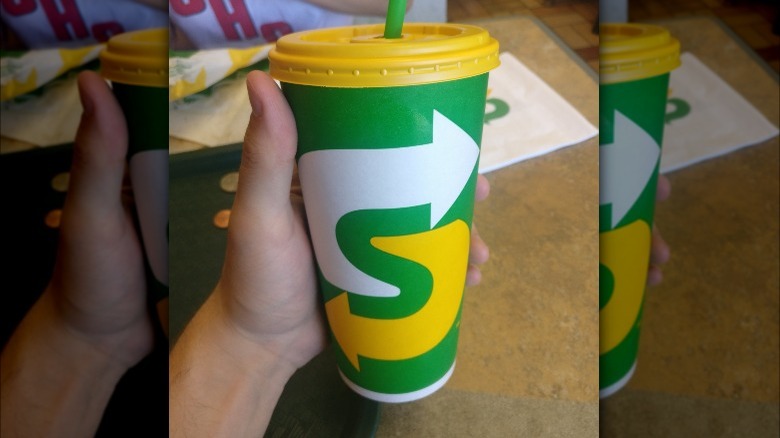 hand holding Subway beverage 