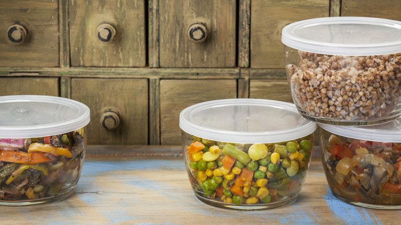 Leftover food in containers in front of a brown cabinet