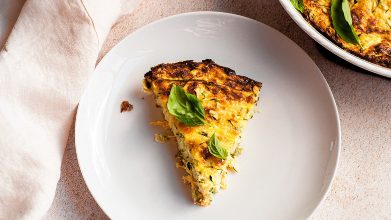 Quiche garnished with basil leaves