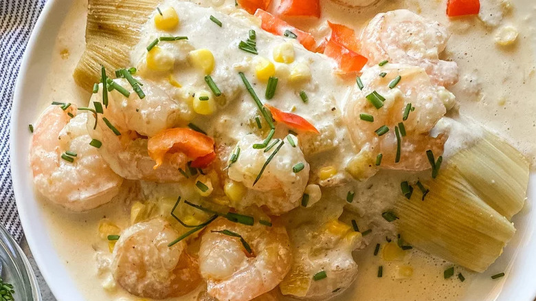 Tamale topped with shrimp and cream.