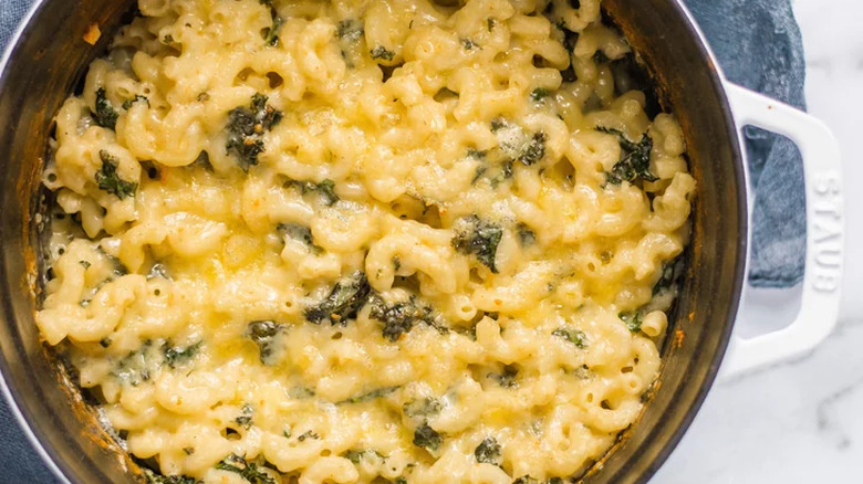 Dutch oven full of baked mac n' cheese, with spinach.