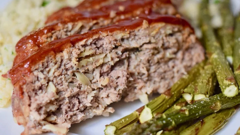 Meatloaf slices topped with ketchup.