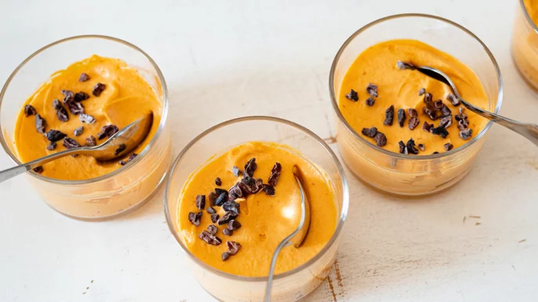 Small dishes of pumpkin pudding with cocoa nibs