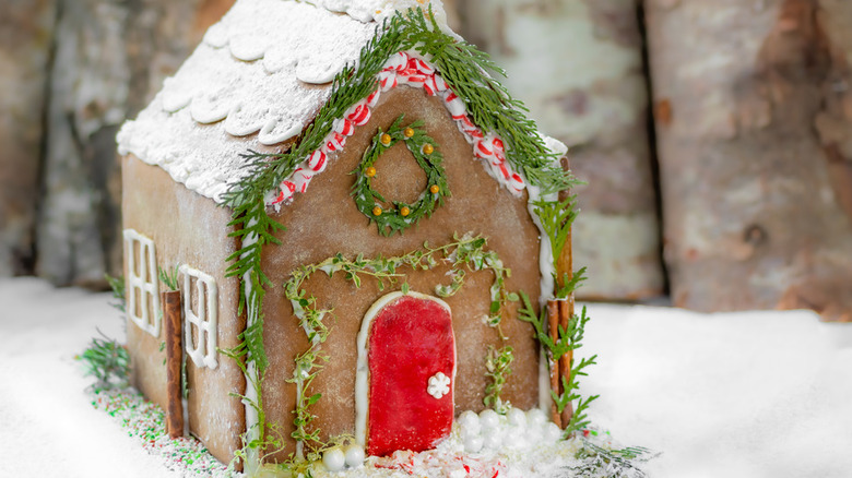 Gingerbread house with red door and sugar on roof