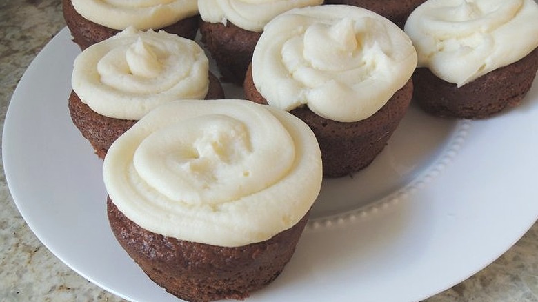 Plate of gingerbread cupcakes with white frosting