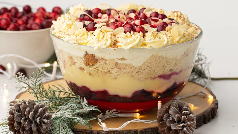 Large bowl of layered red fruit, cream, and cake