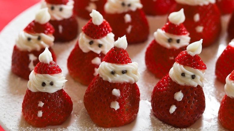 Rows of strawberries decorated like Santas