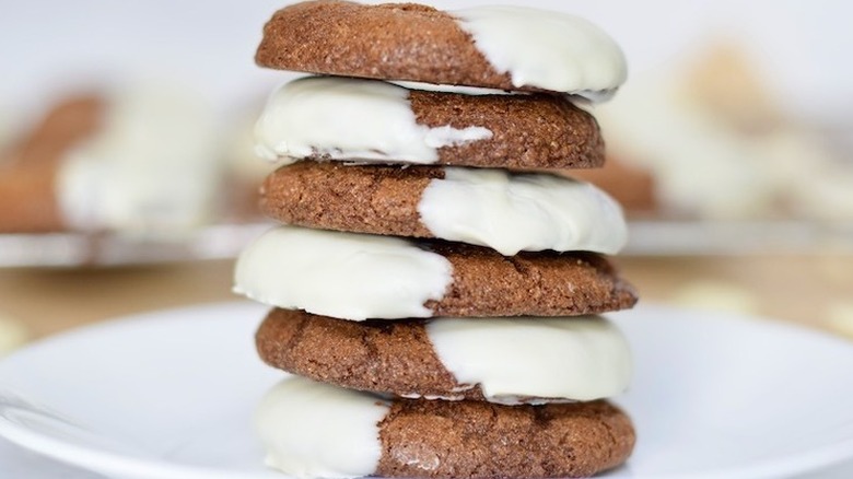 Stack of ginger cookies half dipped in white chocolate