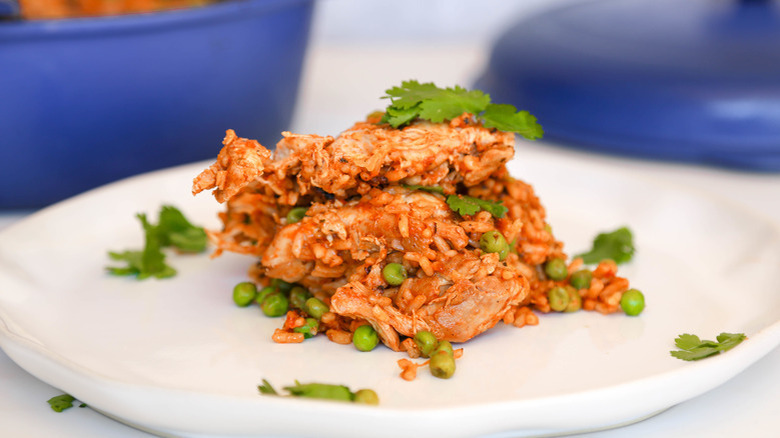 Chicken, rice, and peas on plate