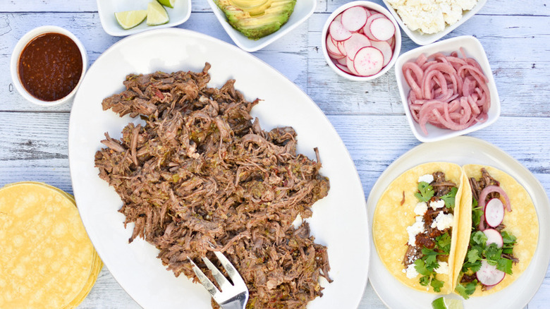 Shredded meat with tortillas and toppings