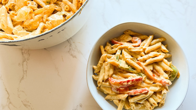 Bowl and pot of pasta with sauce