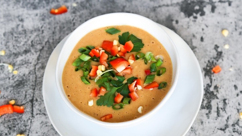 Bowl of soup topped with vegetables