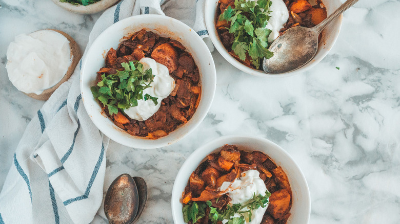 Bowls of vegetable stew with sour cream