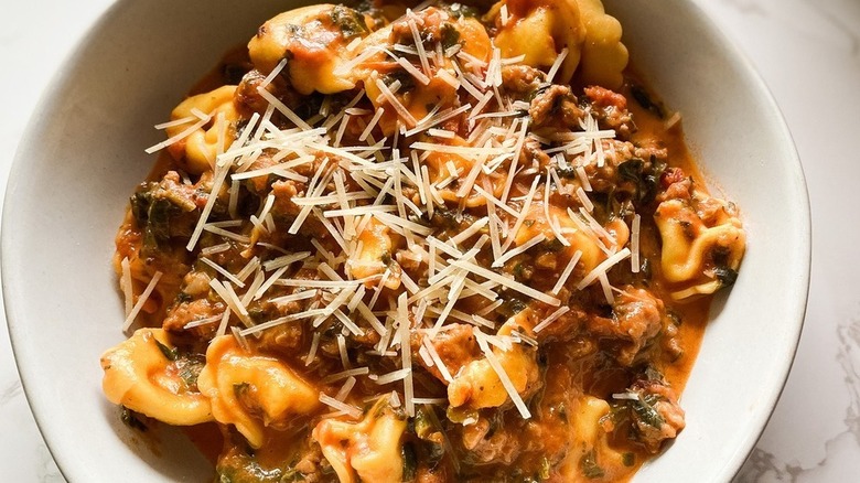 Tortellini with sauce in pot