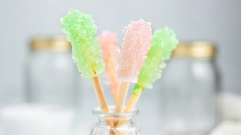 sticks of homemade rock candy in jar