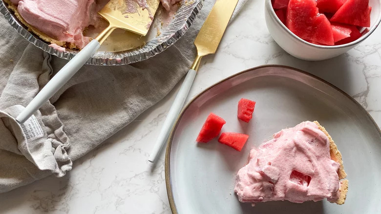 Slice of watermelon pie with serving knife