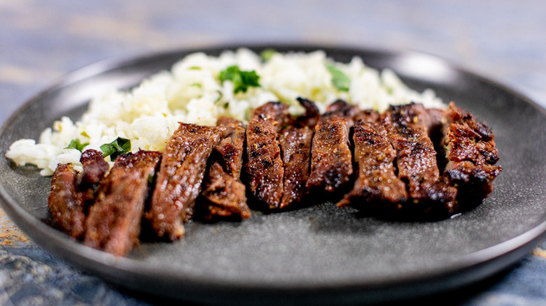 Sliced grilled steak with rice