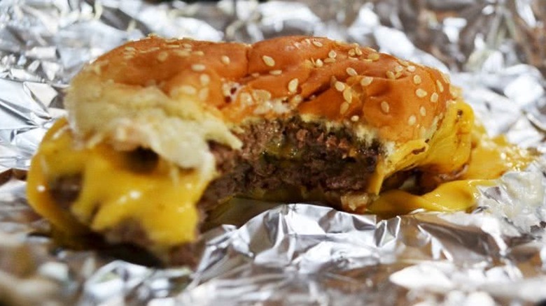 Burger on foil with a bite out