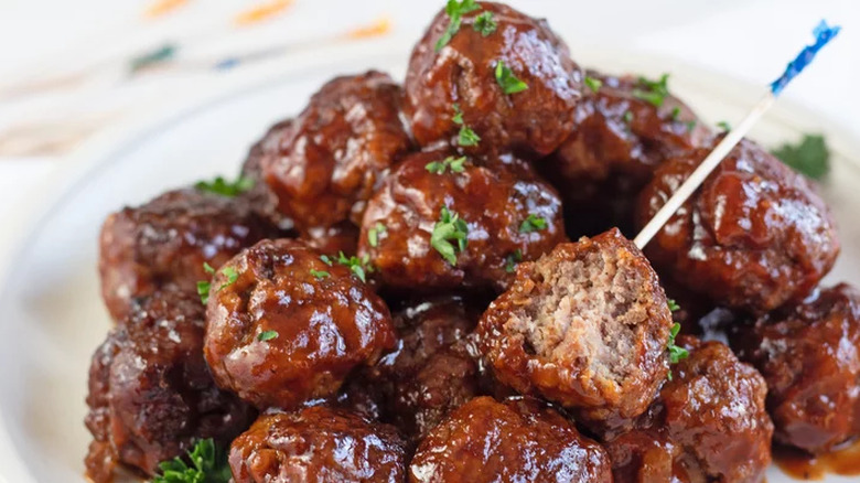 Several saucy meatballs on a plate