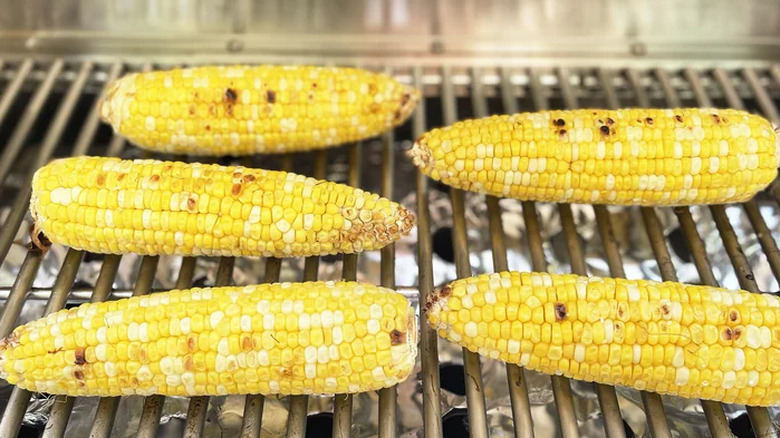 Five ears of corn on a grill