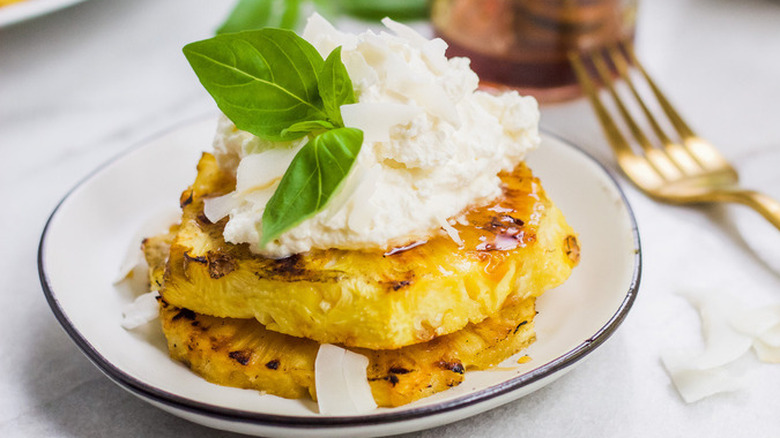 Grilled pineapple slices with whipped cream