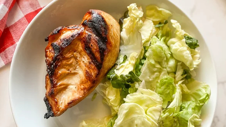 Grilled chicken breasts with salad